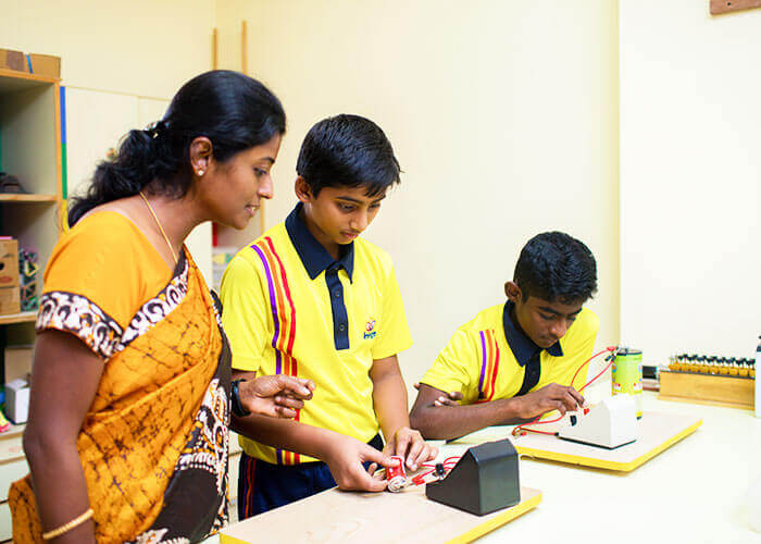 Teacher guiding students in a hands-on science experiment
