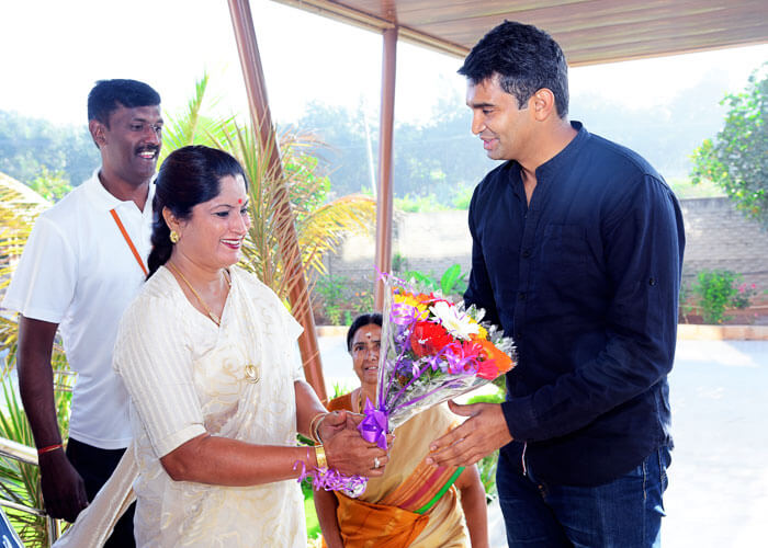 Guest being welcomed with flowers during a special event at NewAge World School.