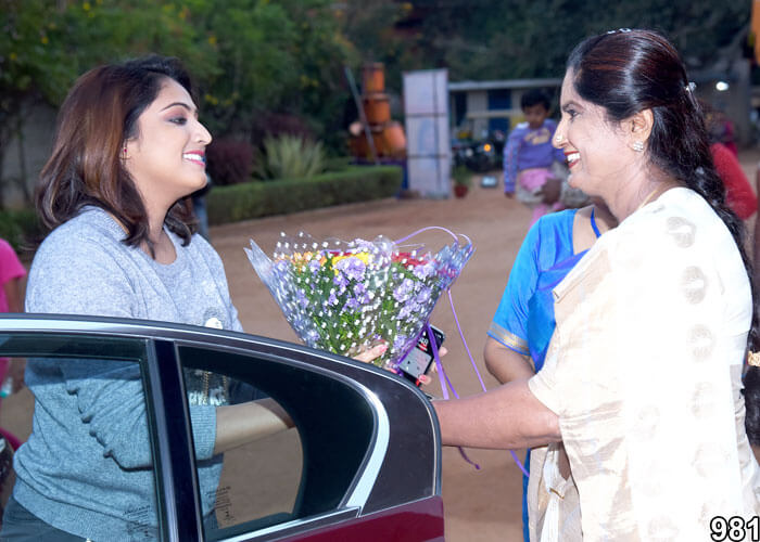 Guest being welcomed with flowers during an event at NewAge World School.